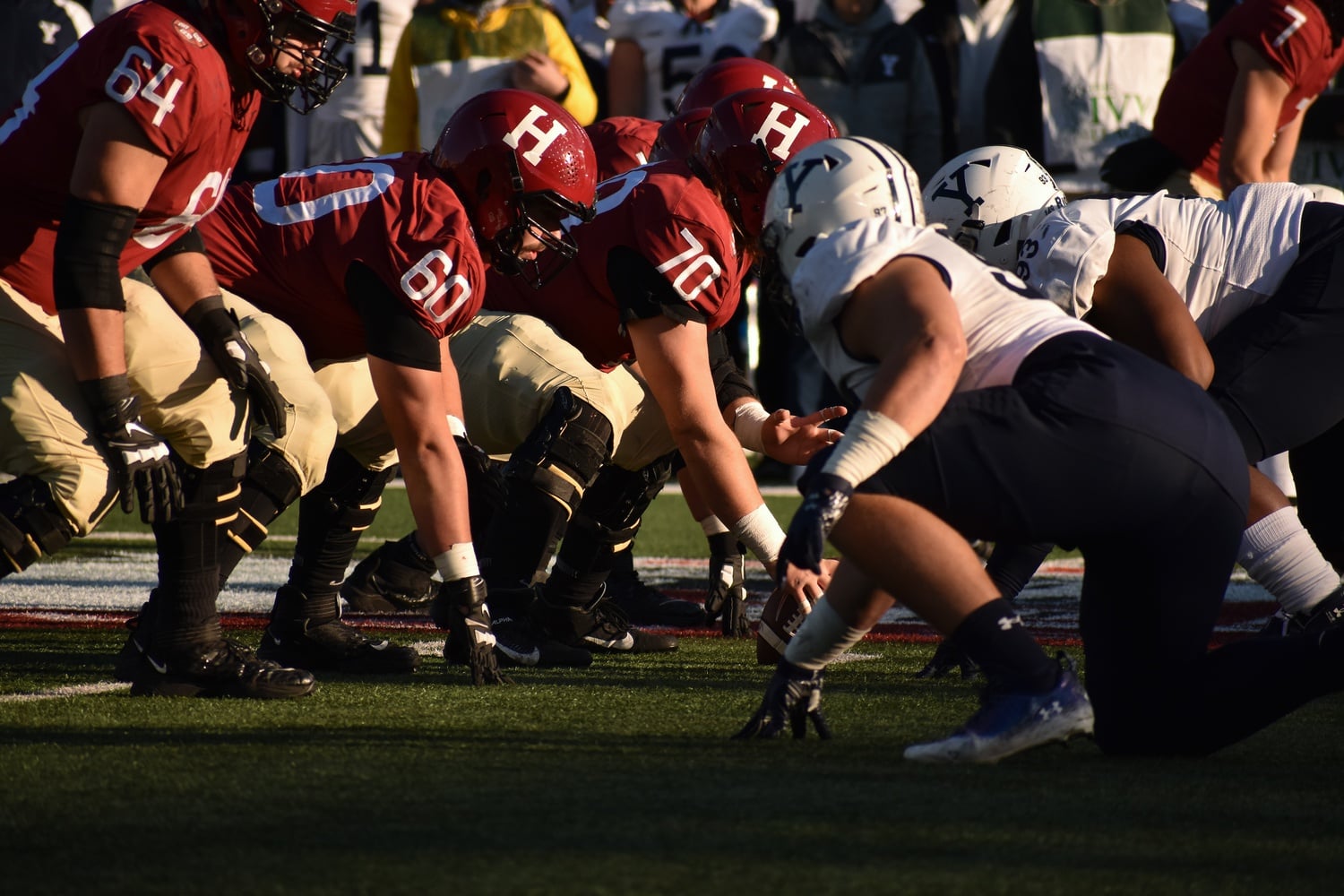 Harvard football offense lines up for a play in the 138th rendition of "The Game" at Harvard Stadium on Nov. 19, 2022. This year, the Crimson will face the Bulldogs for the annual Harvard-Yale game in New Haven, Conn. on Nov. 18, 2023.