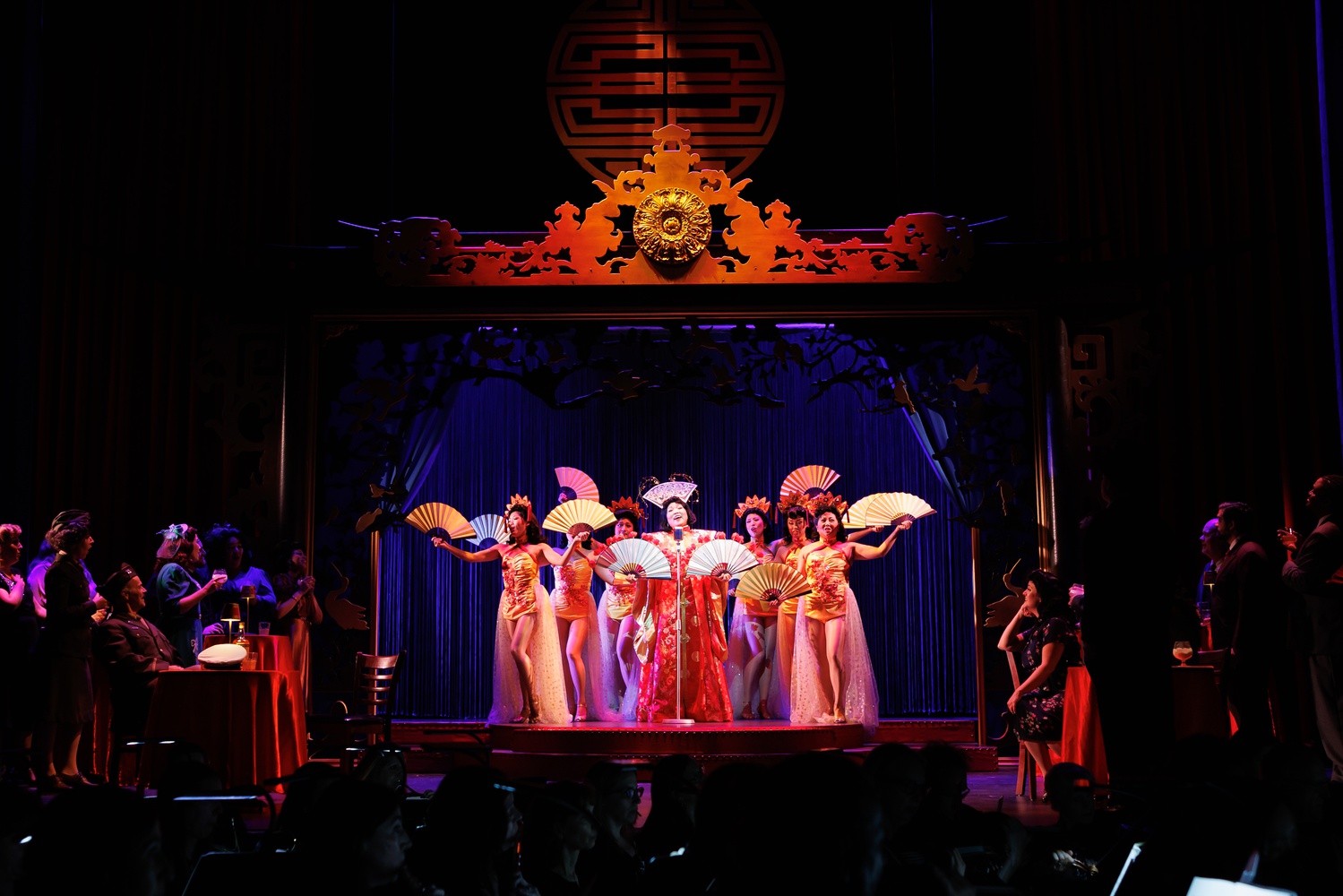 Nightclub performer Butterfly (Karen Chia-Ling Ho, at mic) entertains patrons in Boston Lyric Opera's new production of "Madama Butterfly"