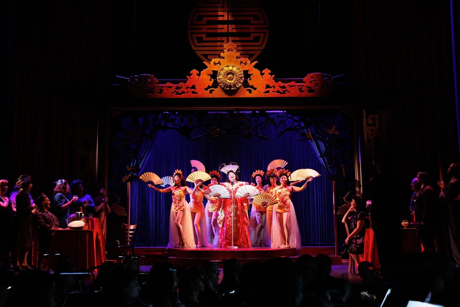 Nightclub performer Butterfly (Karen Chia-Ling Ho, at mic) entertains patrons in Boston Lyric Opera's new production of "Madama Butterfly"