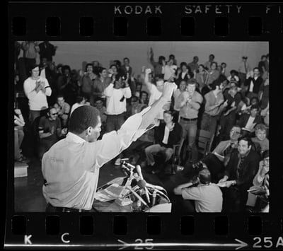 Cover image for A man speaks to a crowd of others incarcerated at Walpole State Prison in a 1971 rally.
