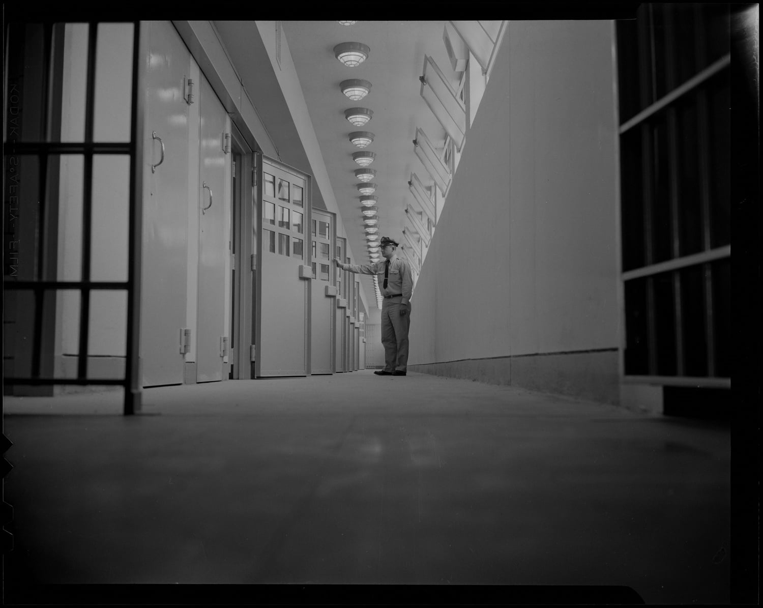 A prison guard at Walpole stands in a row of cells in 1959, three years after the prison opened.