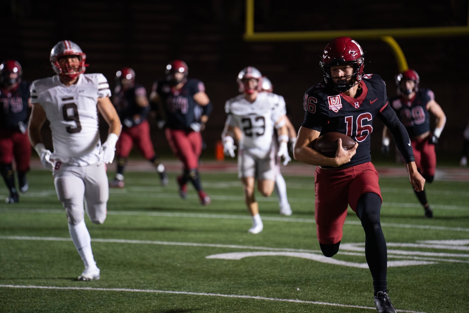 Junior quarterback Charles DePrima hustles with the ball at Harvard's 2023 Ivy opener against Brown on Friday night. DePrima had a career-high in rush yards, running for 113  yards and three touchdowns.