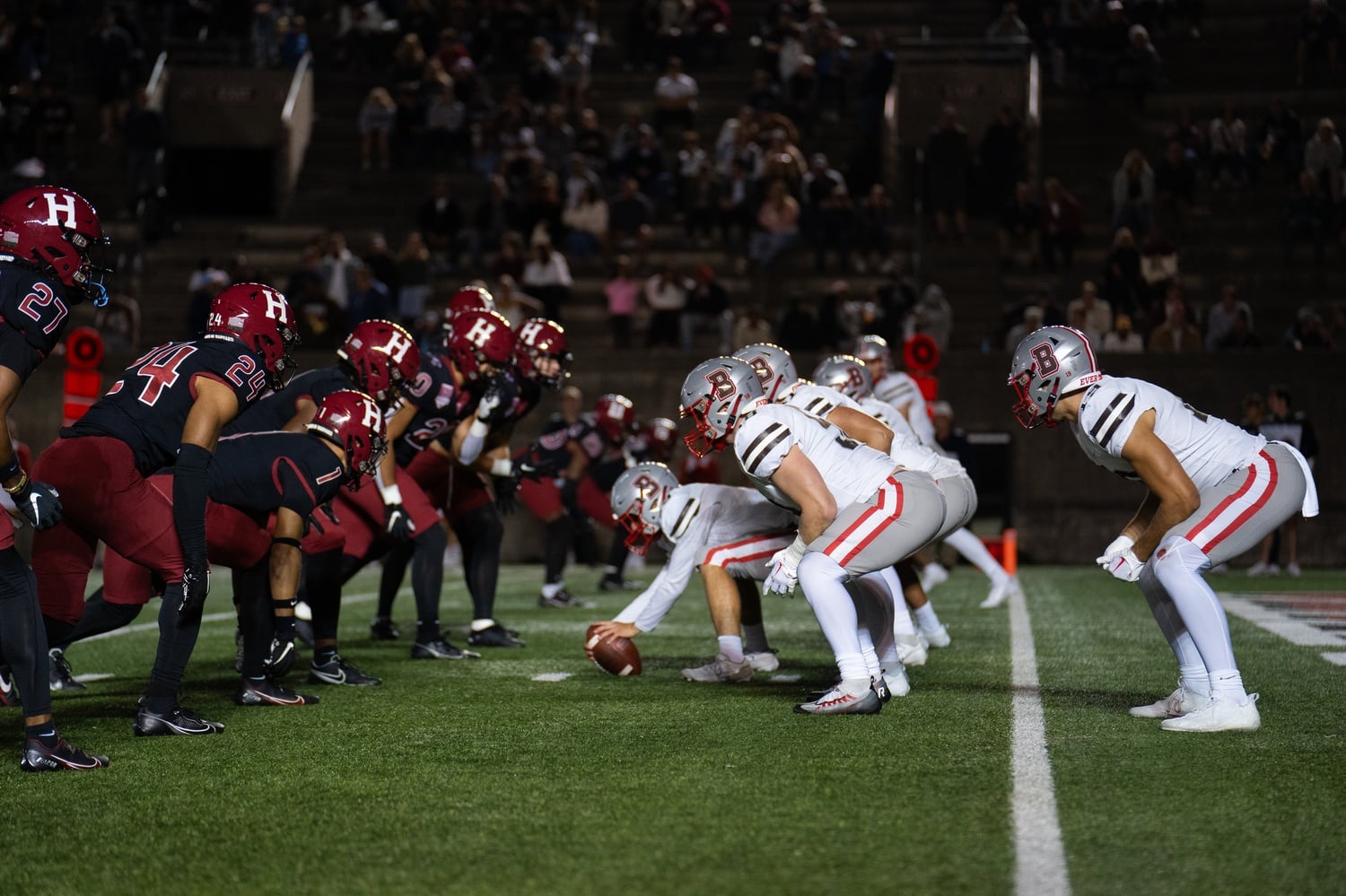 The Crimson's defensive line prepares to push the Brown Bears back during the 2023 Ivy League season opener against the Brown Bears. Harvard will travel to Providence on Saturday looking to extend a 12-game winning streak over Brown.