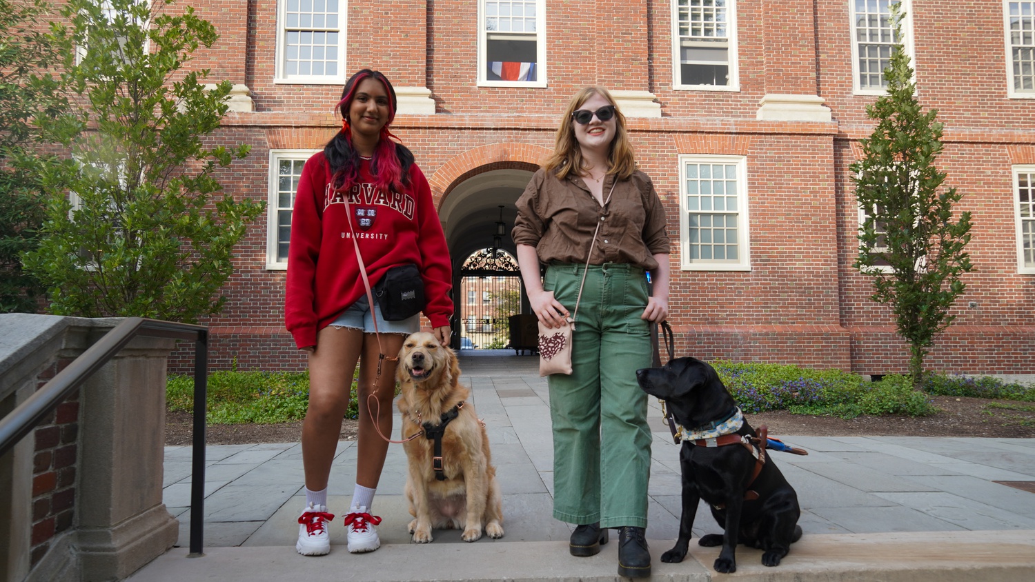 Sonya R. Ganeshram ’24 (left), and Emma Vrabel ’25 (right) with their dogs Athena and Holly.
