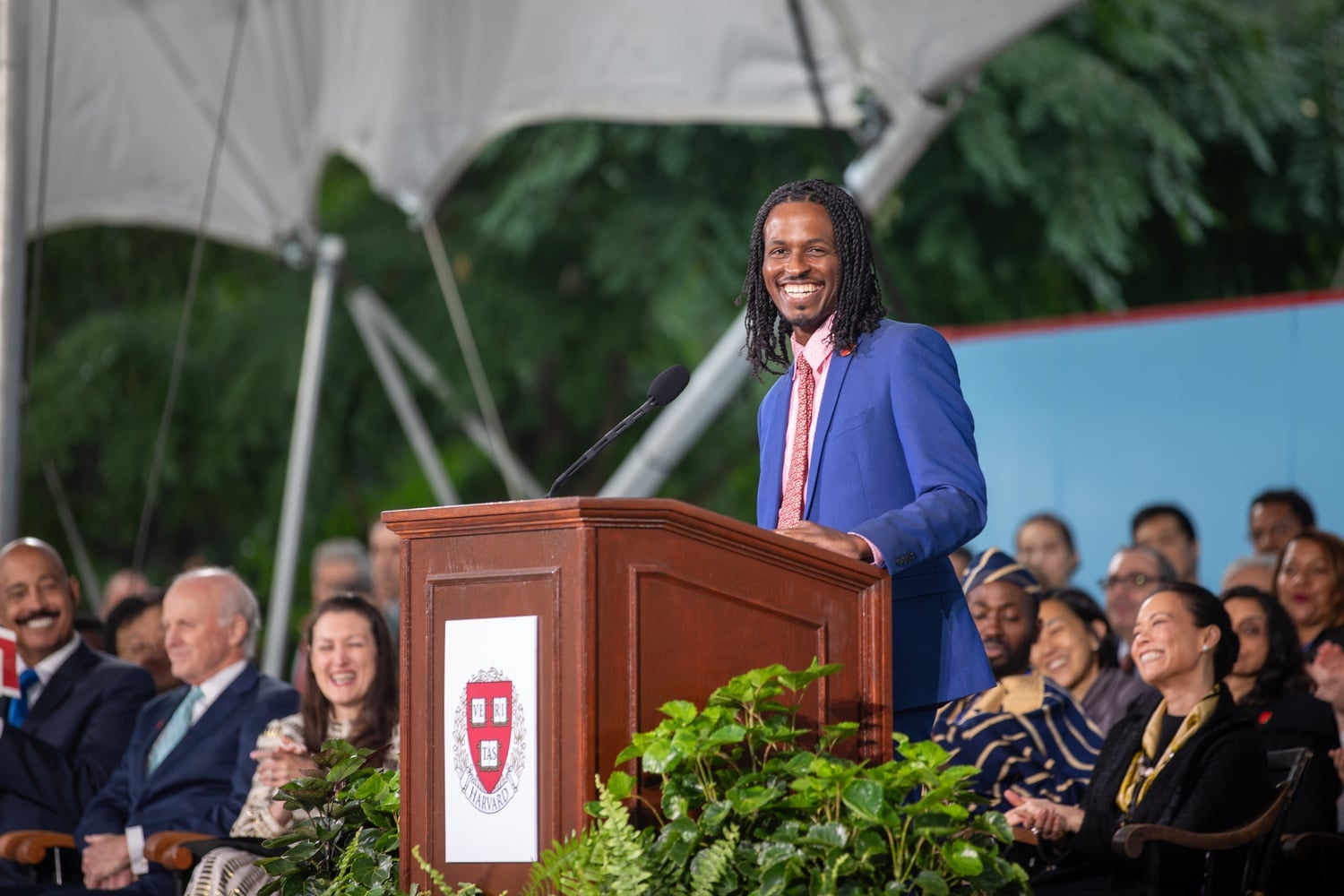 Tracy “Ty” Moore II ’06 concluded a series of speeches preceding University President Claudine Gay’s inaugural address, lauding attendees for braving the rain.