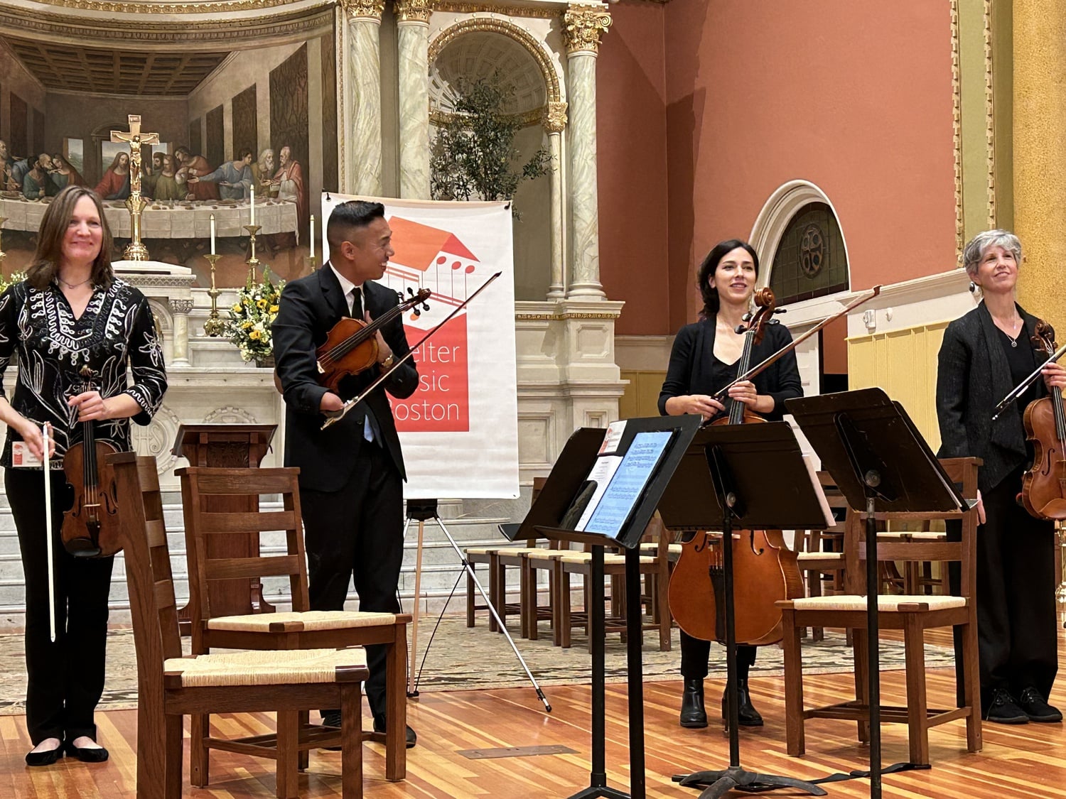 The members of Shelter Music Boston's quartet smile on stage during their concert "Songs of Life."