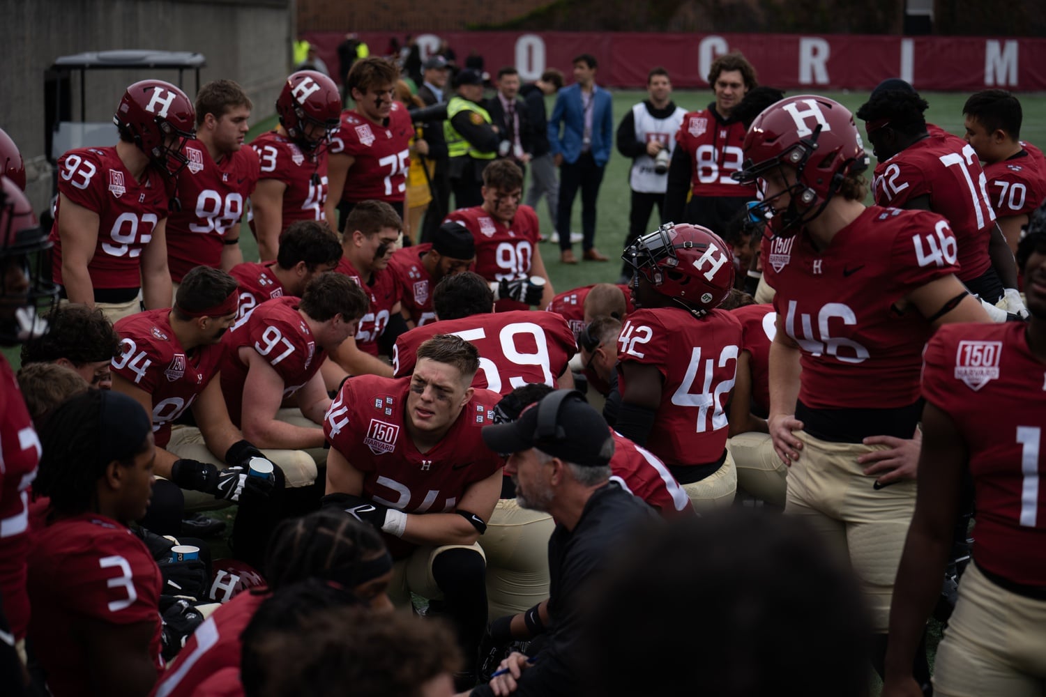 Harvard's defensive squad hits the sideline for a mid-game talk at the Crimson's Saturday game against Howard.
