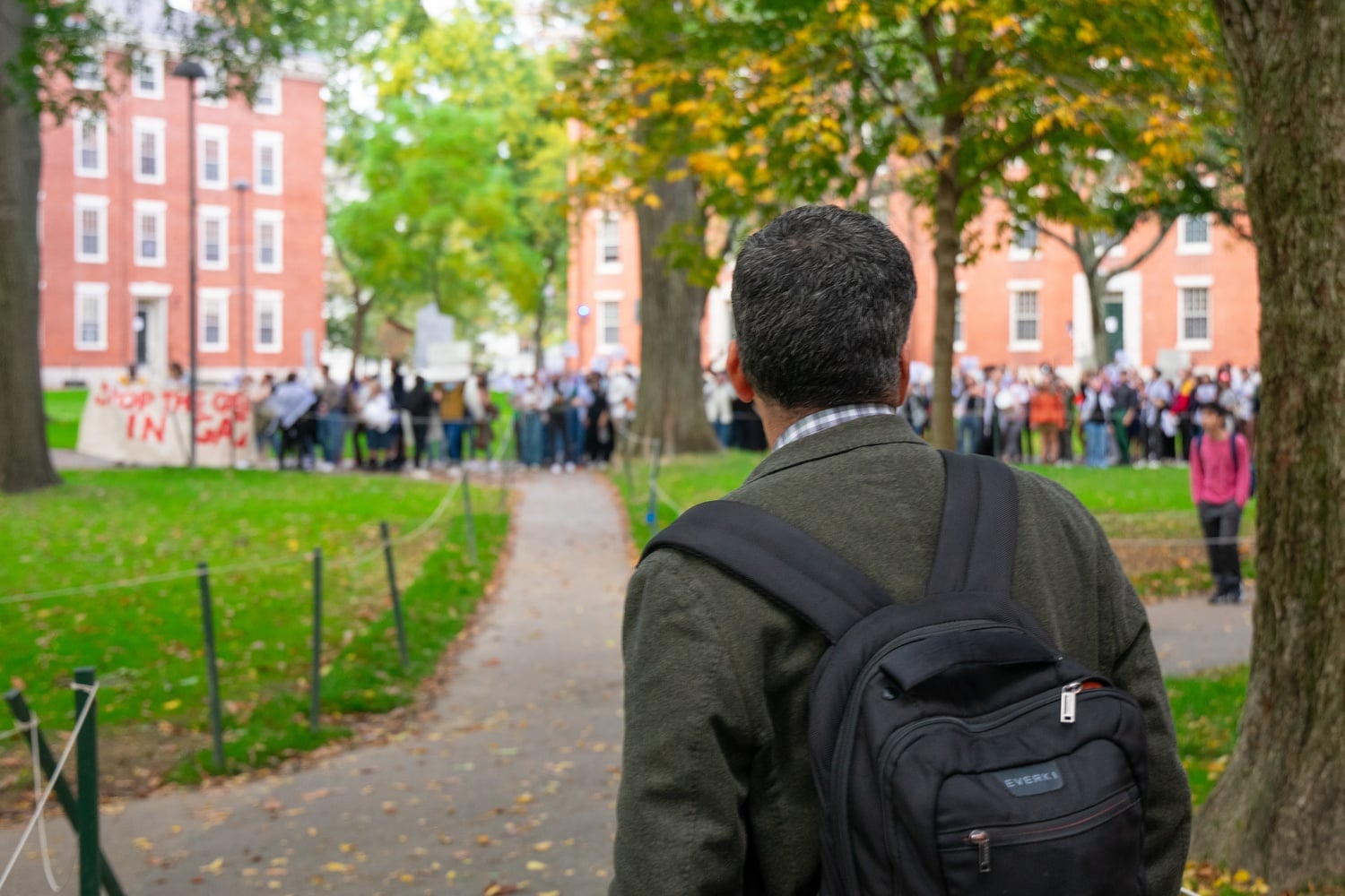 Dean Khurana watches protesters in the Old Yard as they call on him to take action.