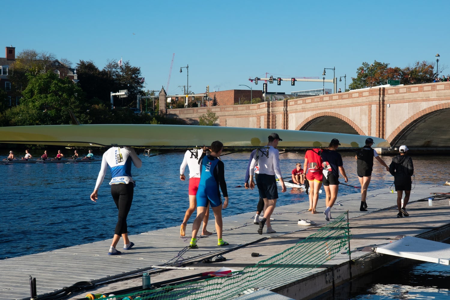 The Harvard men's heavyweight rowing team carries its shell back into Weld Boathouse after practice on October 19, 2023.