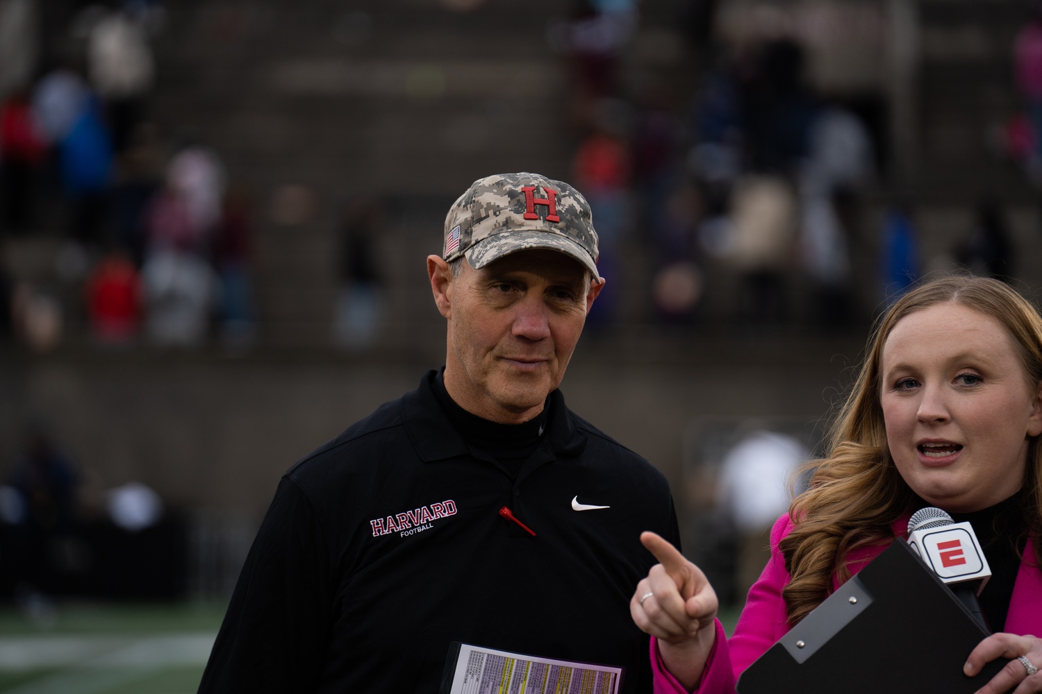 Harvard football head coach Tim Murphy speaks with ESPN during Harvard's game against Howard on October 14, 2023. Murphy can set the Ivy League's all-time wins record for coaches with a victory tomorrow against Princeton.