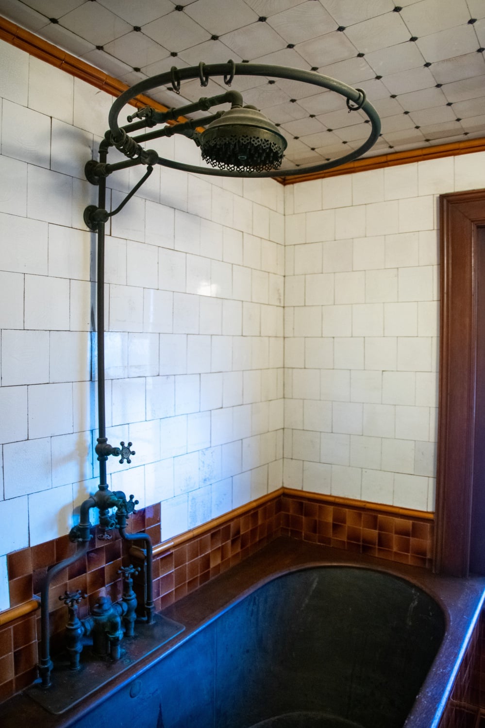 A rusted and eccentric zinc tub occupies about one-third of the Warren House half-bath.
