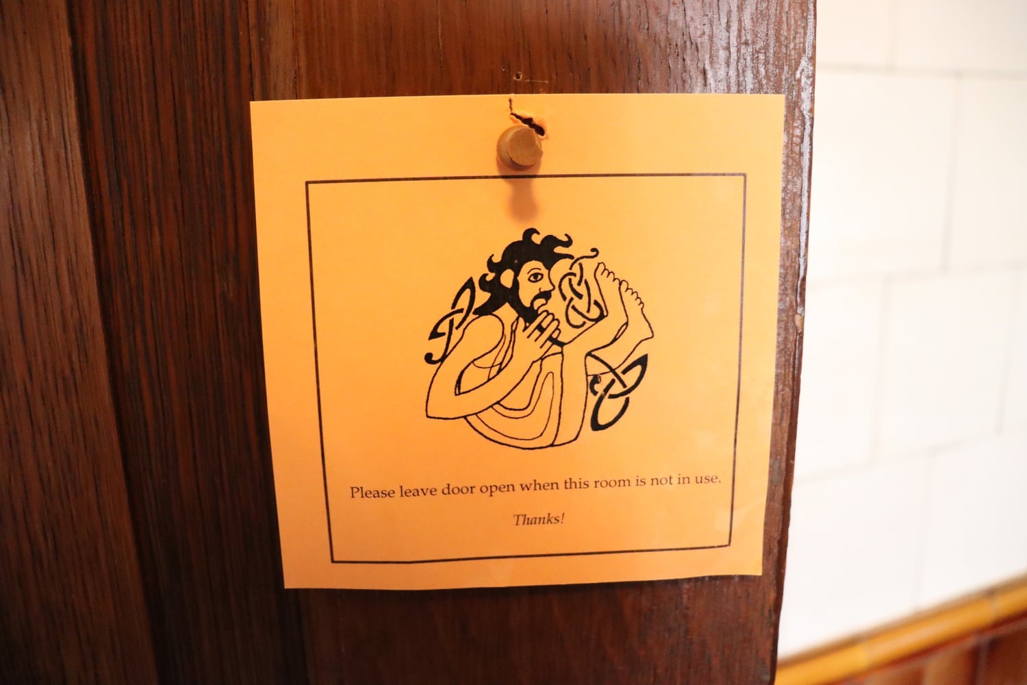 A Celtic illustration brings the character of the Celtic Languages and Literatures Department to this bathroom relic of departments past.