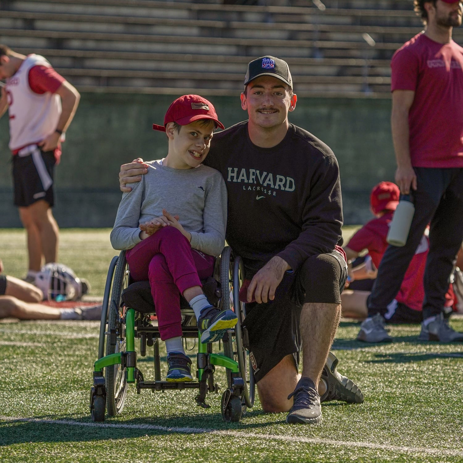 Junior middie Owen Gaffney shares a moment with Braxton, the men's lacrosse team's Team IMPACT buddy, at the squad's charity Burrito Bowl on October 21, 2023.