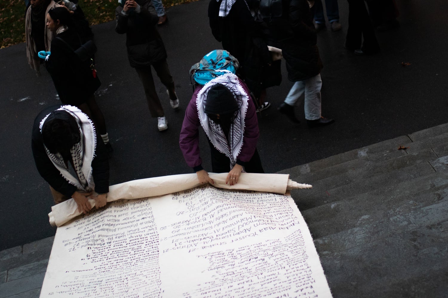 Demonstrators roll up a more than 140-yard-long canvas listing the names of Palestinians killed in the violence in Gaza.
