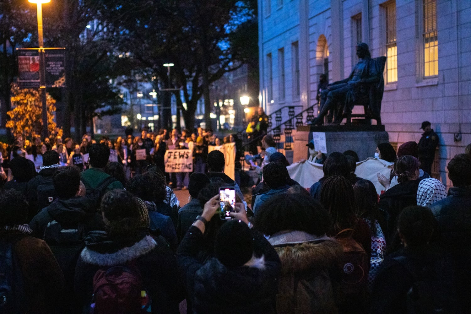 More than 100 protesters gathered outside University Hall in support of nine pro-Palestine student organizers occupying the building Thursday evening.
