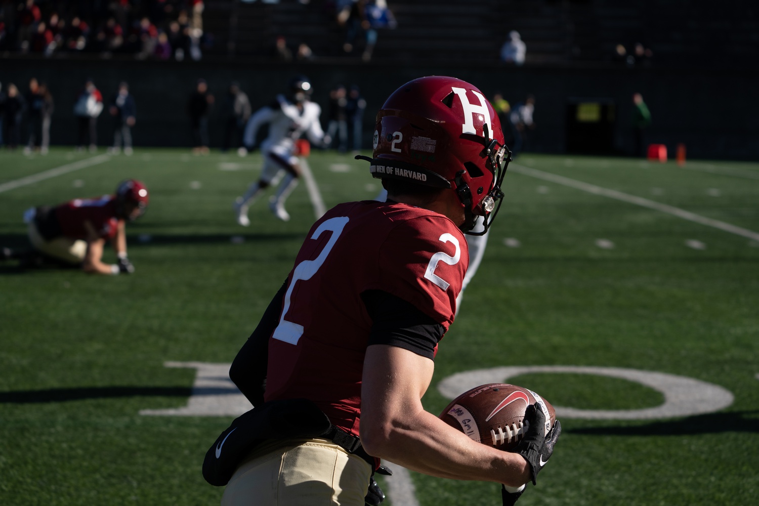 Sophomore wide receiver Cooper Barkate looks to make his move up the field in the Crimson's decisive defeat of Penn on Nov. 11, 2023, which granted Harvard a share of the Ivy League title.