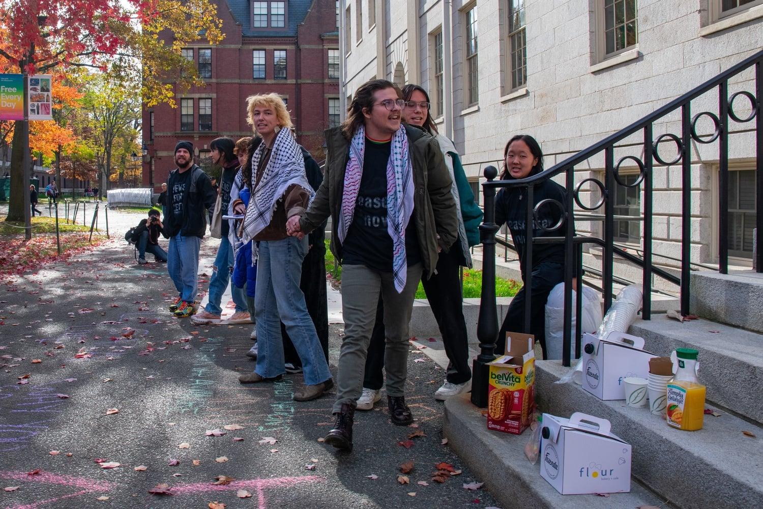 The nine student protesters who participated in the sit-in overnight exit the basement of University Hall Friday morning.