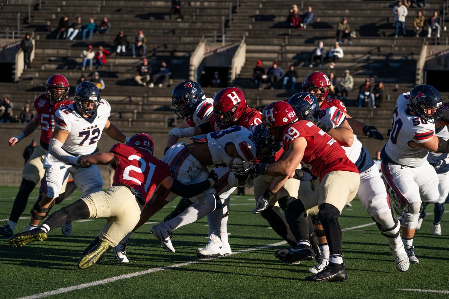 The Harvard defense attempts to stop the Quakers' offense on Nov. 11, when the Crimson took down the Philadelphia school for a share of the Ivy League title.