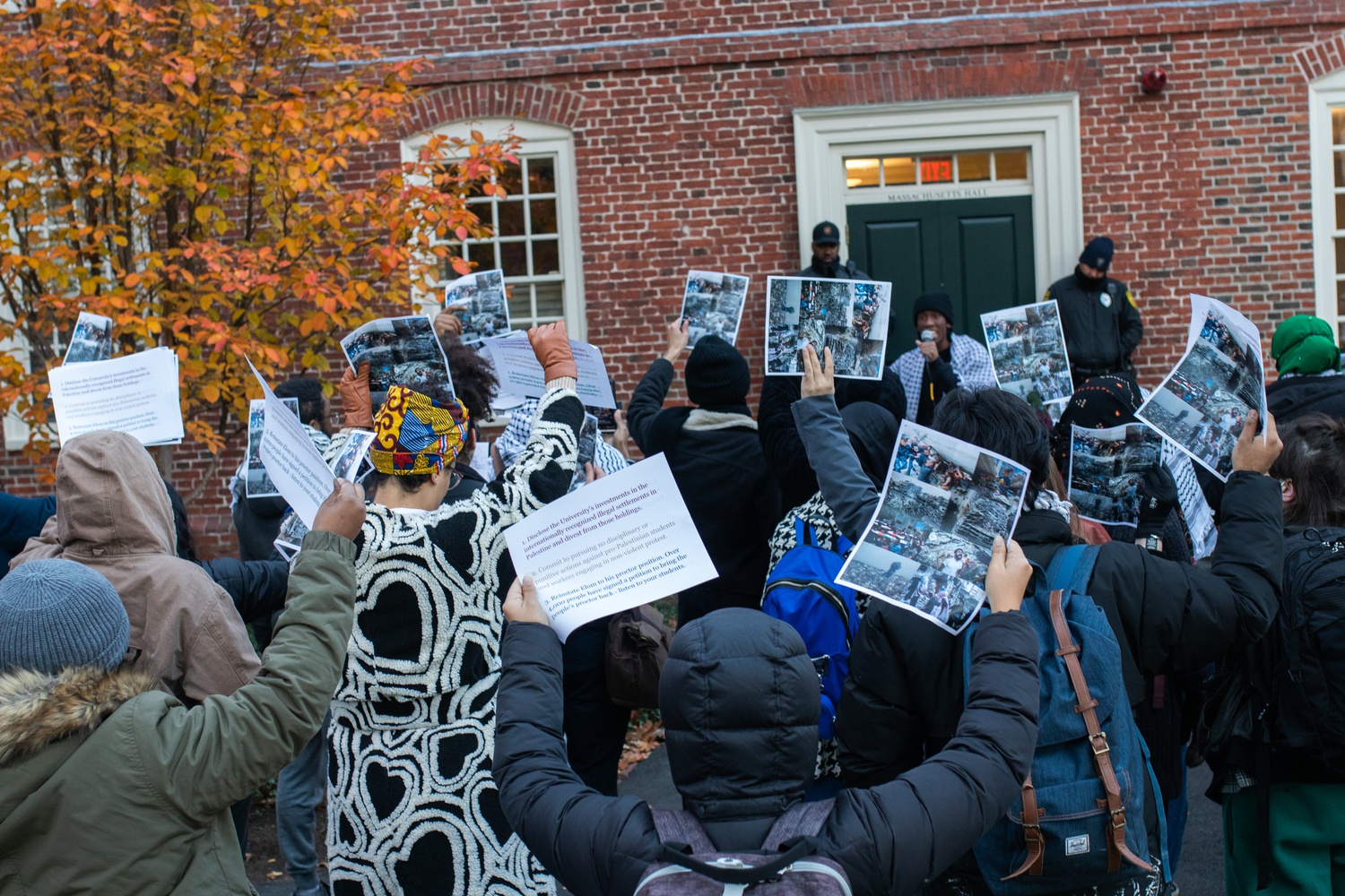 Demonstrators rallied outside of Massachusetts Hall Monday, in part objecting to disciplinary action against pro-Palestine student protesters.