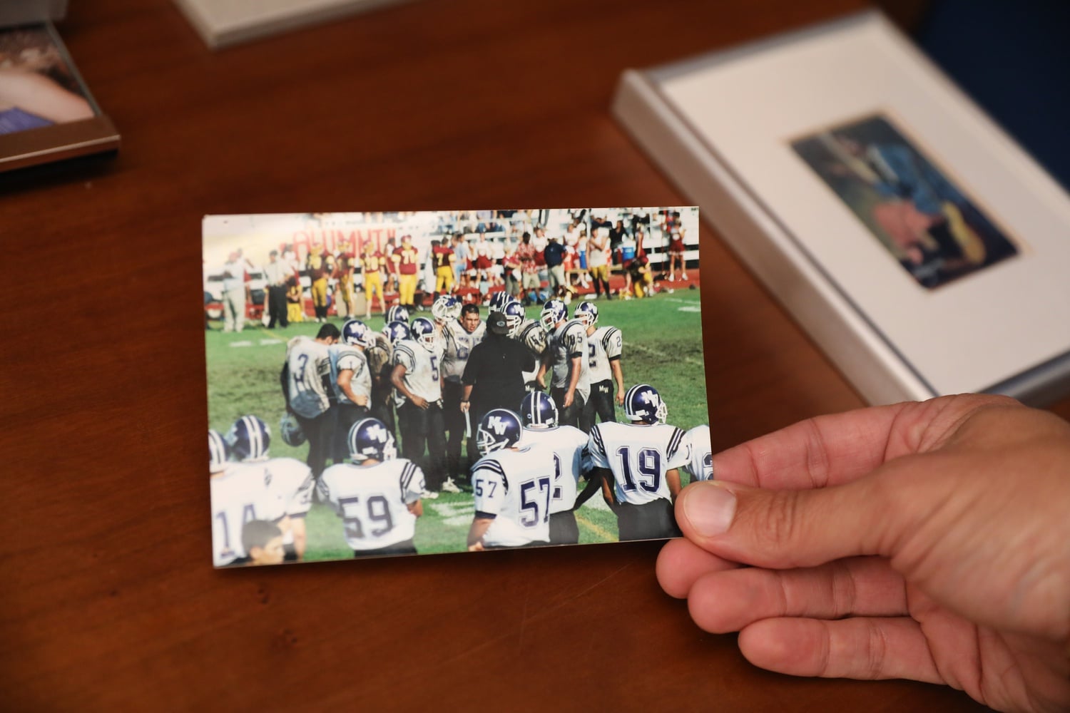 A picture of Andrew Manuel Crespo ’05 in the huddle of his high school football team. He keeps this picture in his office.