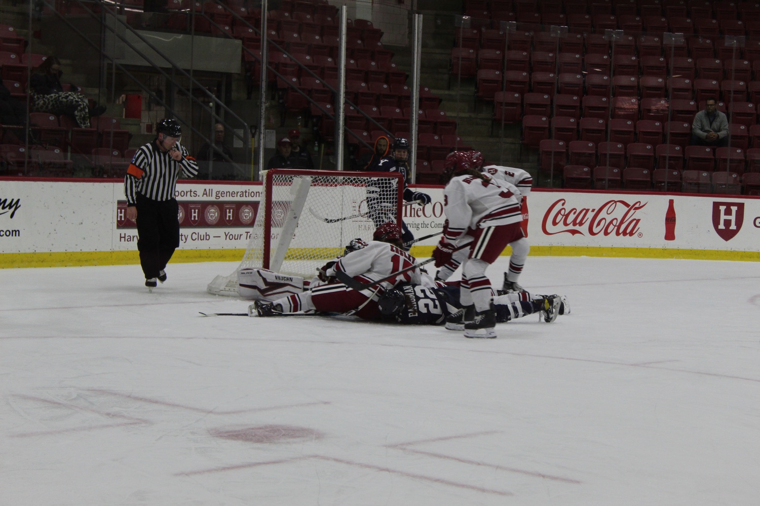 Harvard and Yale converge on the net after a chaotic scramble at Bright-Landry Hockey Center on October 28, 2022.