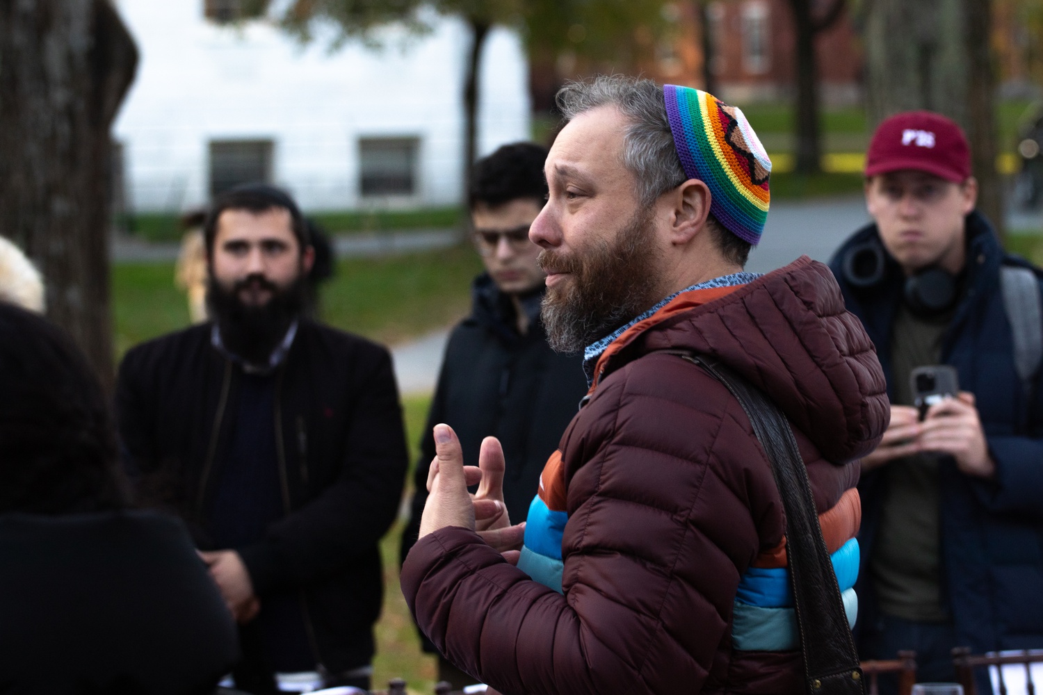 Campus Rabbi Getzel Davis addresses a crowd at a Shabbat table installation in Harvard Yard.