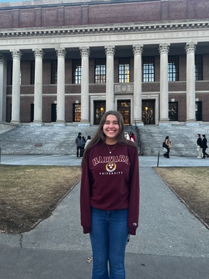 Cover image for Ava in front of Widener