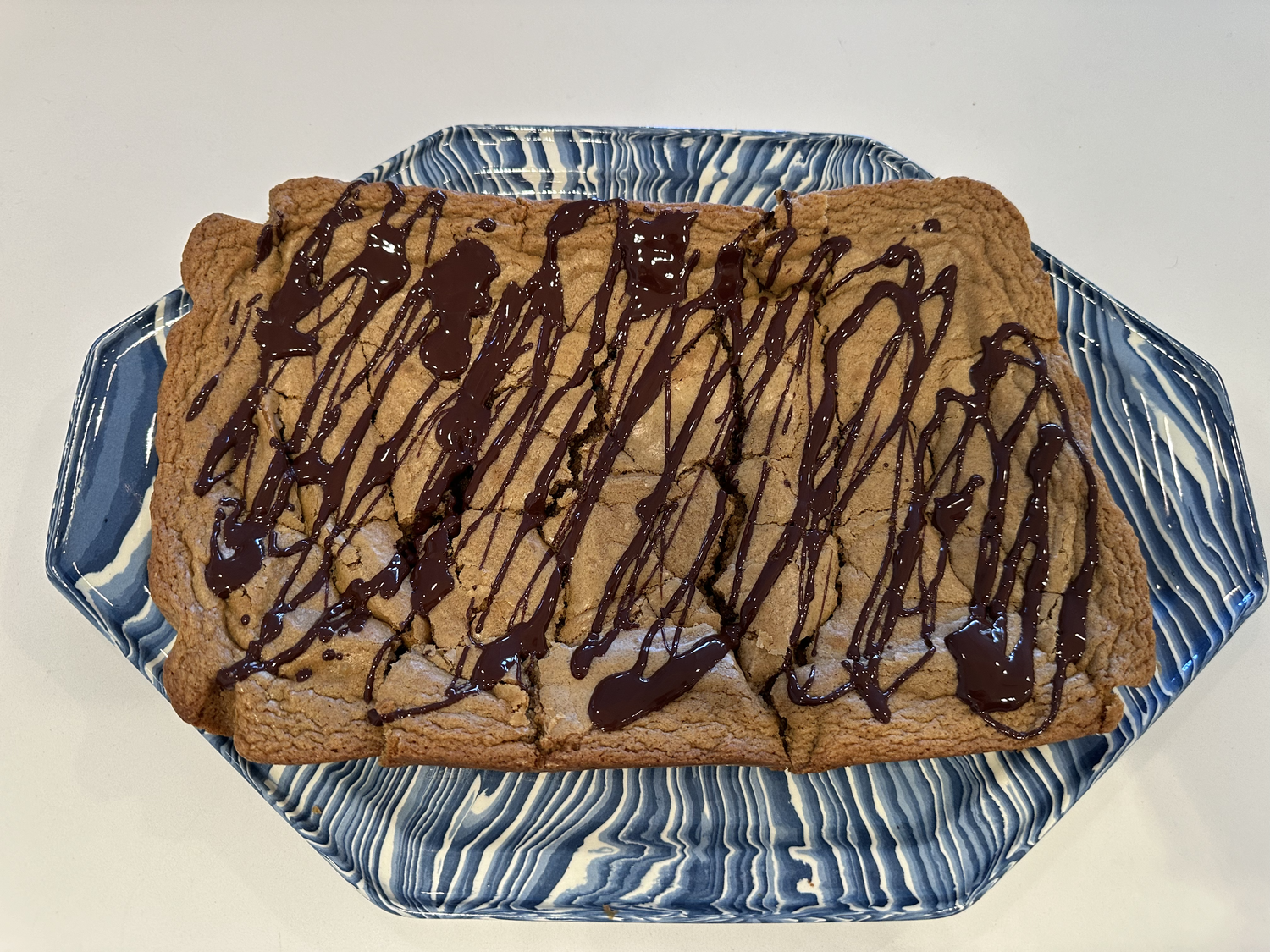 The recipe’s incorporation of freshly grated ginger, cloves, and cinnamon elevate the blondies.