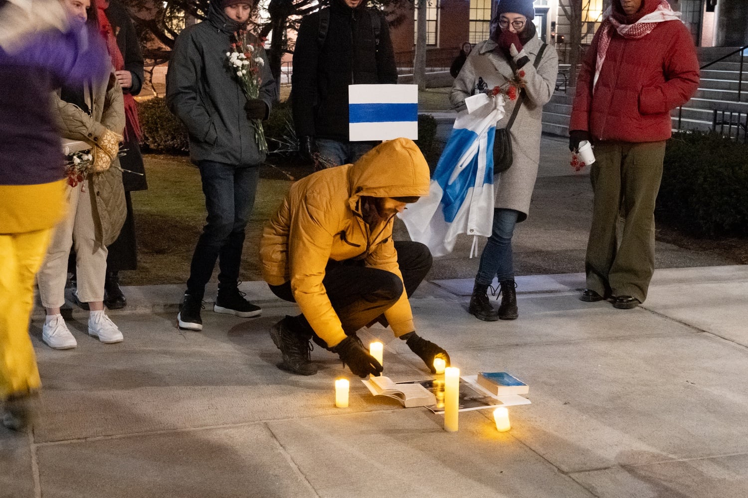 Thirty Harvard affiliates gathered in Harvard Yard to mourn the death of Russian opposition leader Alexey Navalny.