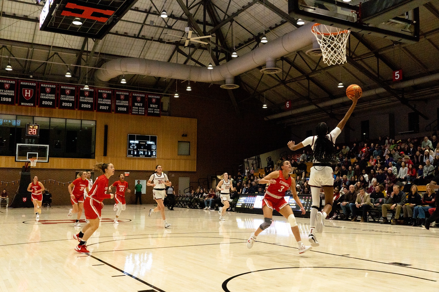 Then-junior Saniyah Glenn-Bello goes for a lay-up in a bout with the Cornell Big Red on Feb. 3 of this year. Glenn-Bello hit a dagger three-pointer to put away UMass to open the 2024 season for the Crimson.
