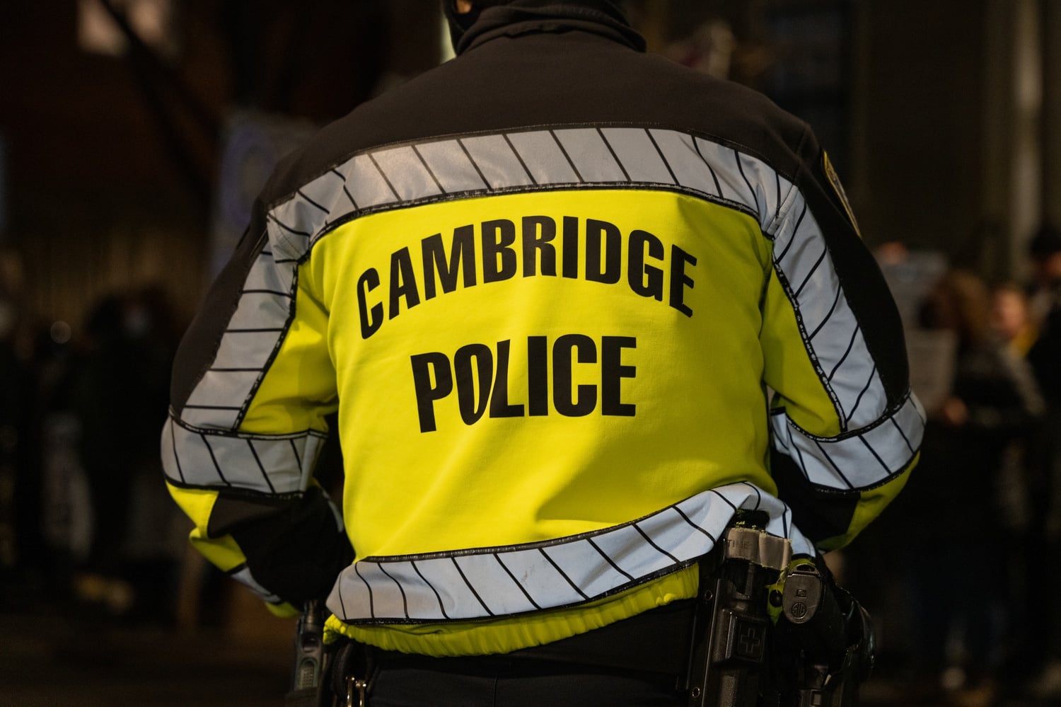 A Cambridge police officer who accidently discharged his firearm in a school bathroom was placed on administrative leave amid an ongoing investigation into the incident.
