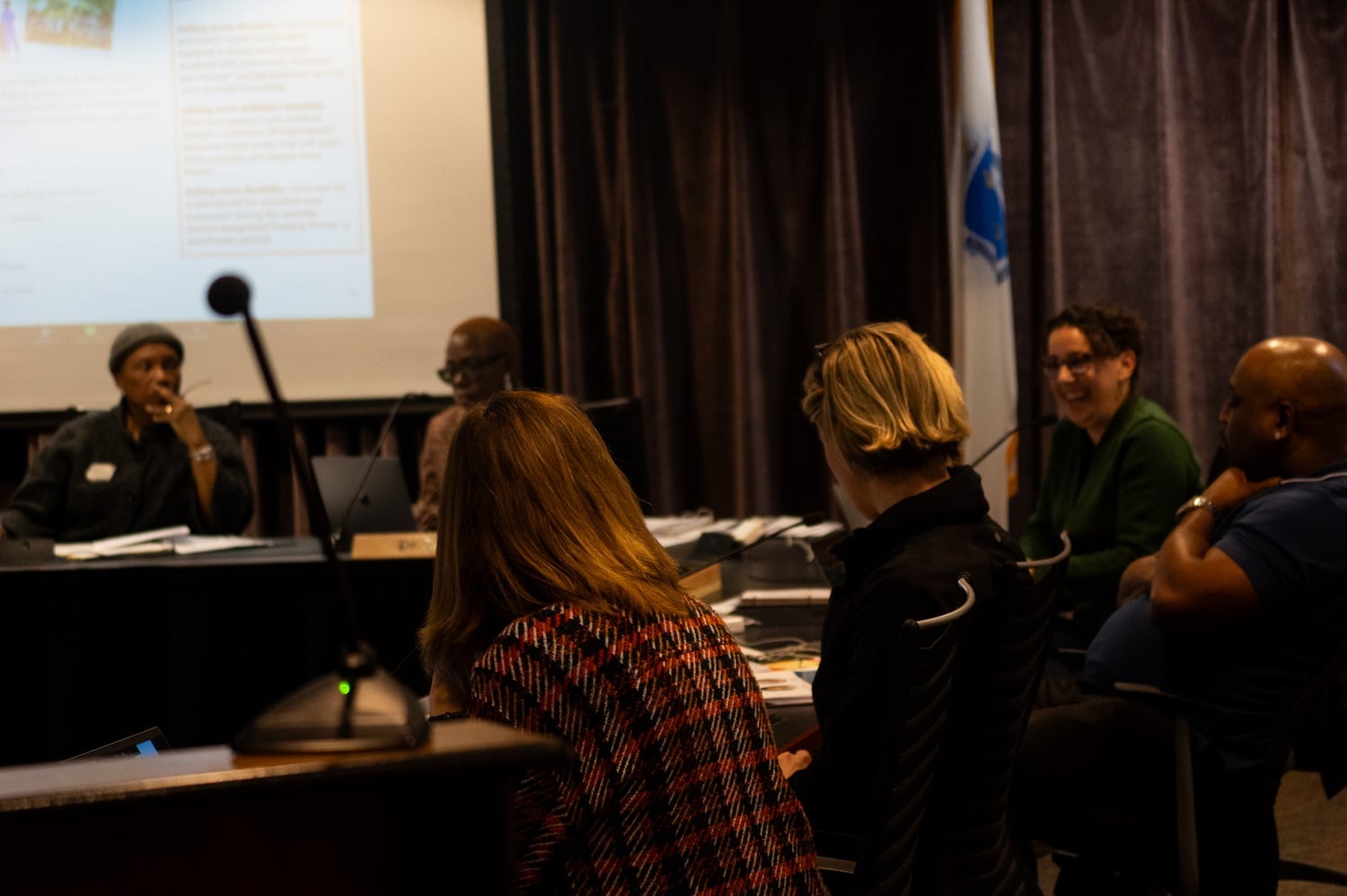 Cambridge educators and residents at a School Committee meeting in March. Attendees at a Tuesday meeting demanded increased pay for paraprofessionals.