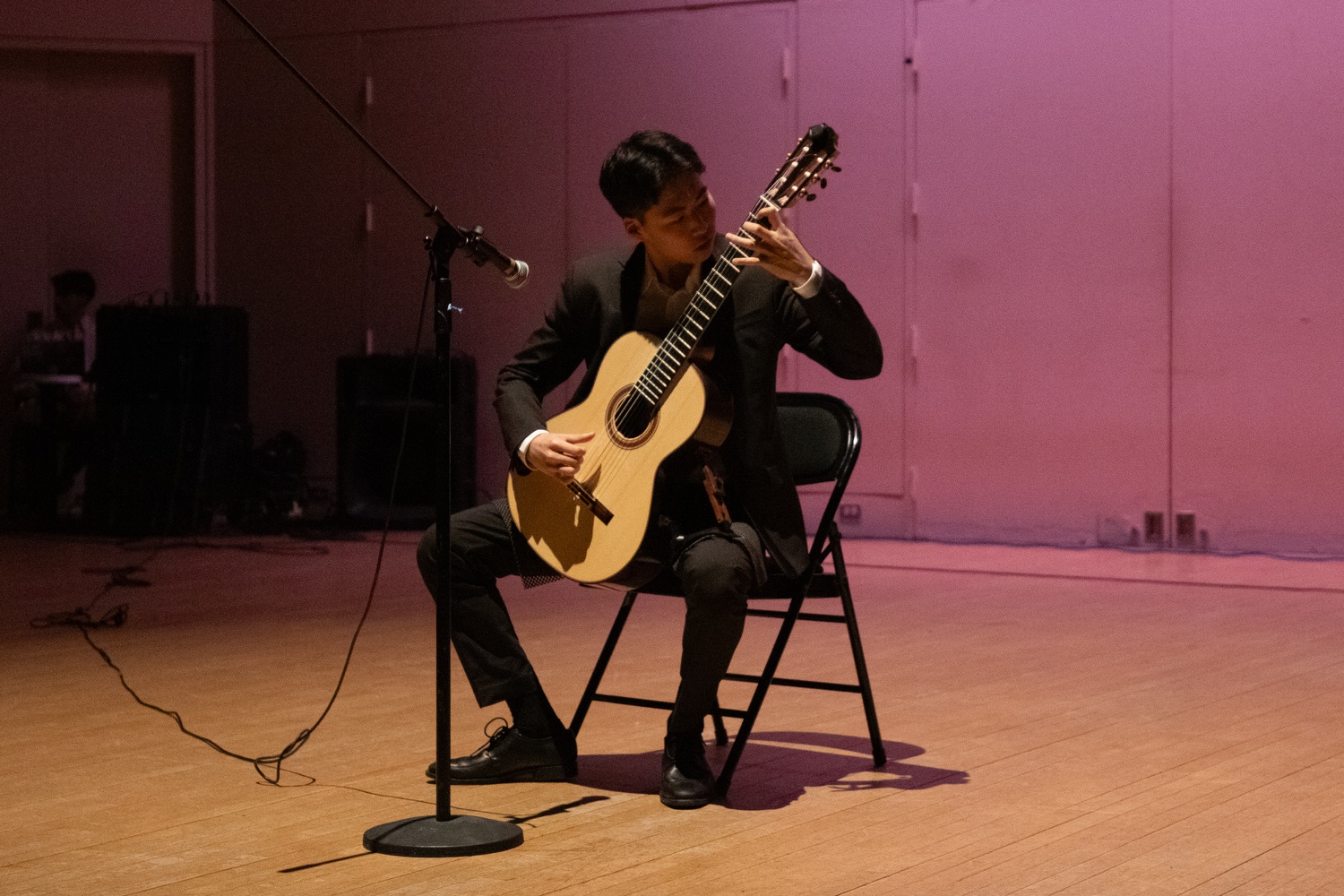 Reade Park '27 performs a guitar solo in the talent showcase part of the Mr. Asian Sensation pageant.