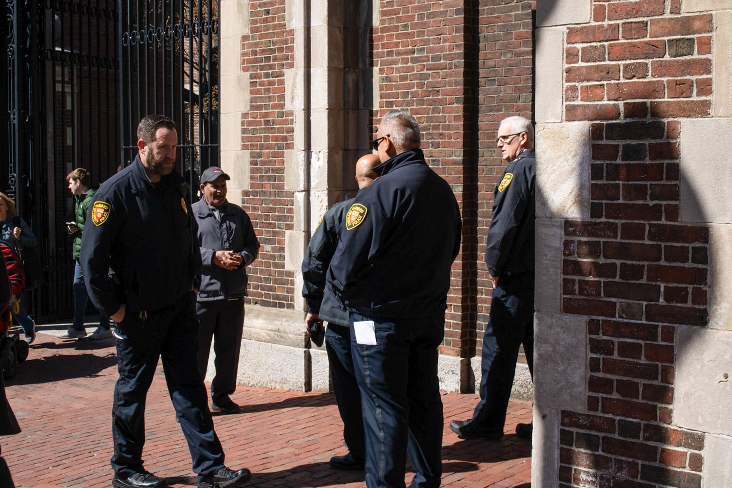A group of Harvard University Police Department stand outside a gate to Harvard Yard after a pro-Palestine encampment led the University to restrict access to the Yard.