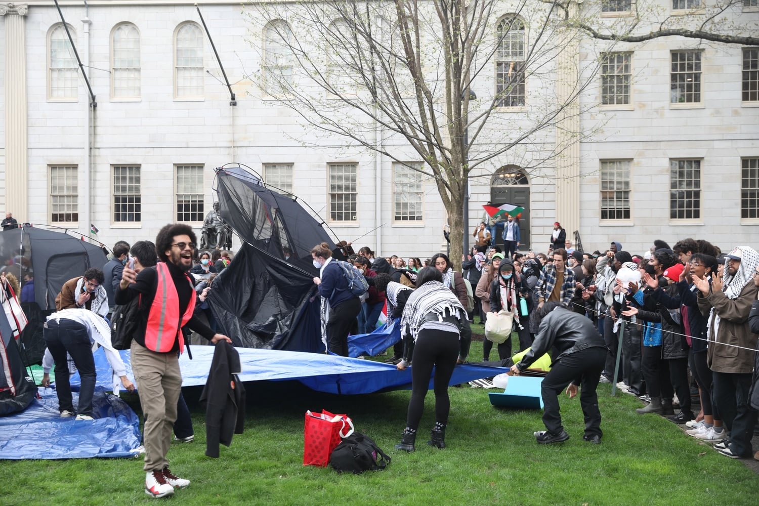 African and African American Resistance Organization organizer Prince A. Williams '25 cheers as students begin to set up an encampment in Harvard Yard.