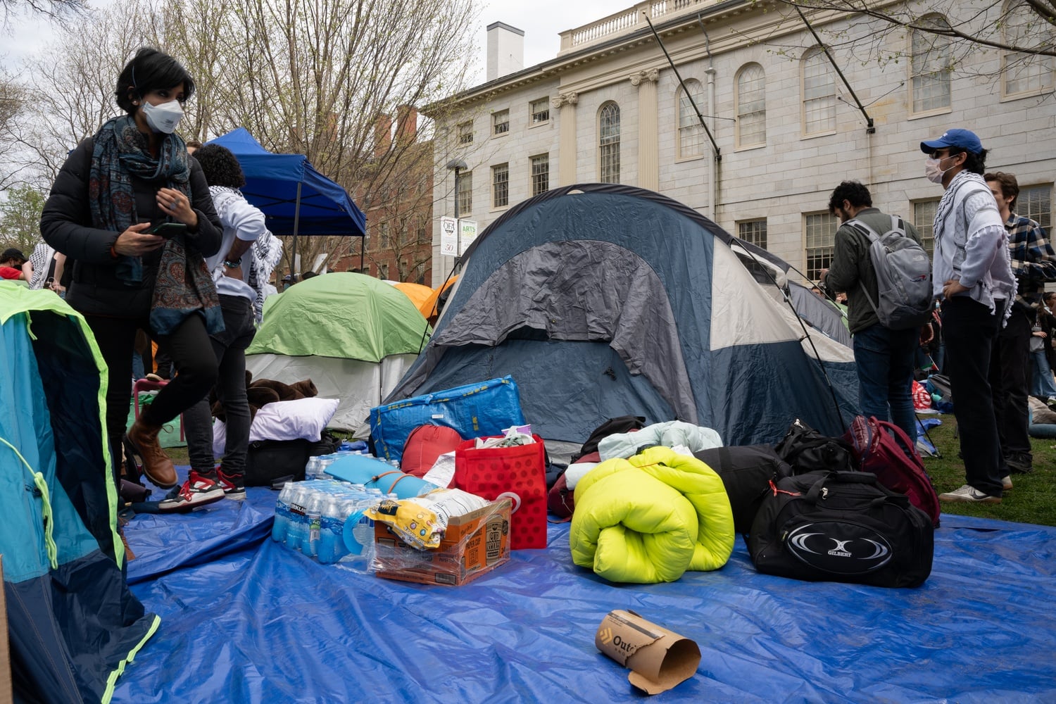 Students put up around 13 tents in a grassy area in front of the John Harvard statue.
