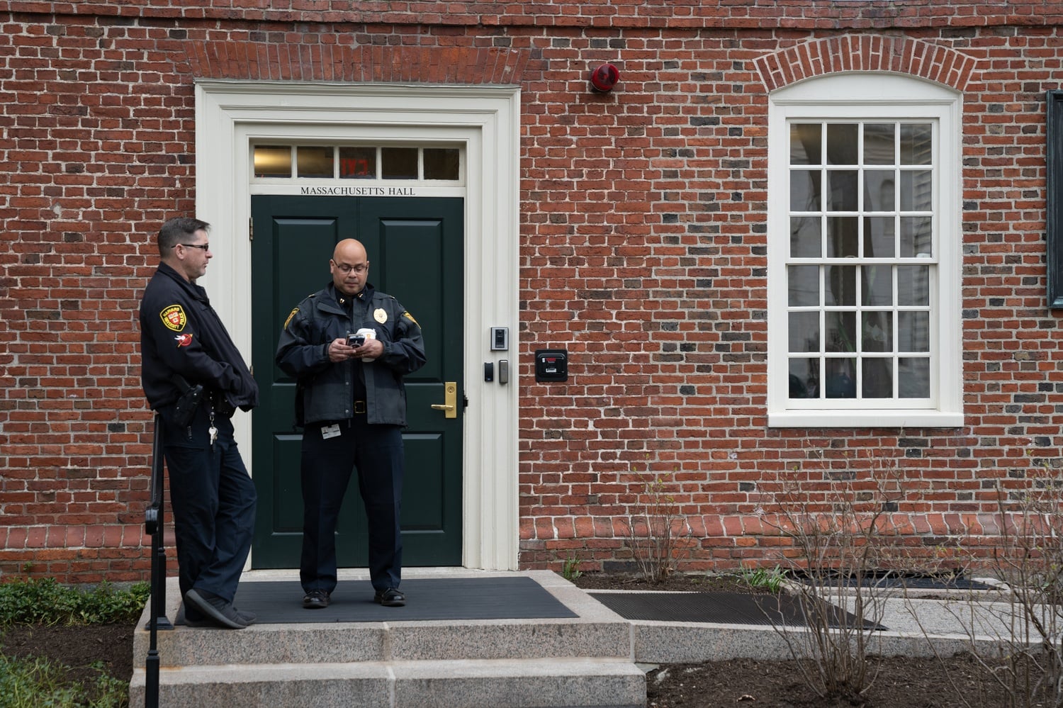 Harvard University police officers stationed outside Mass. Hall during the first week of the encampment. HUPD officers entered the encampment and photographed students on Monday.