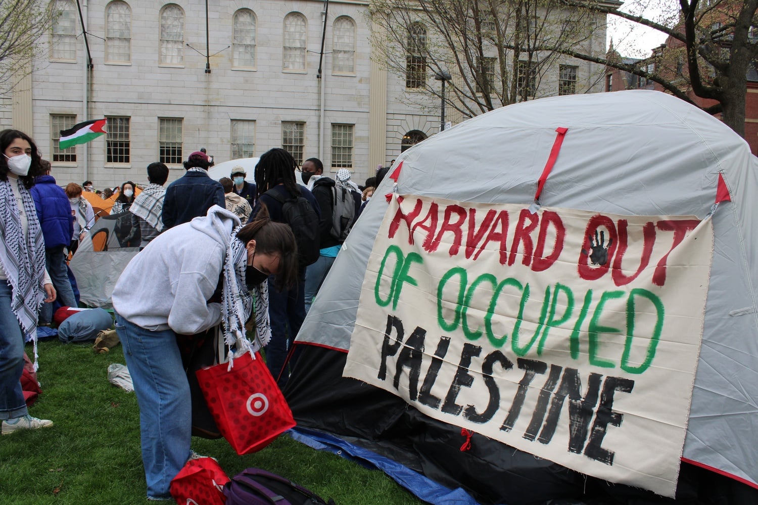 A tent in the pro-Palestine Harvard Yard encampment with a sign for Harvard Out of Occupied Palestine. HOOP took down a poster showing interim Harvard President Alan M. Garber '76 as a devil after criticisms that it was antisemitic.