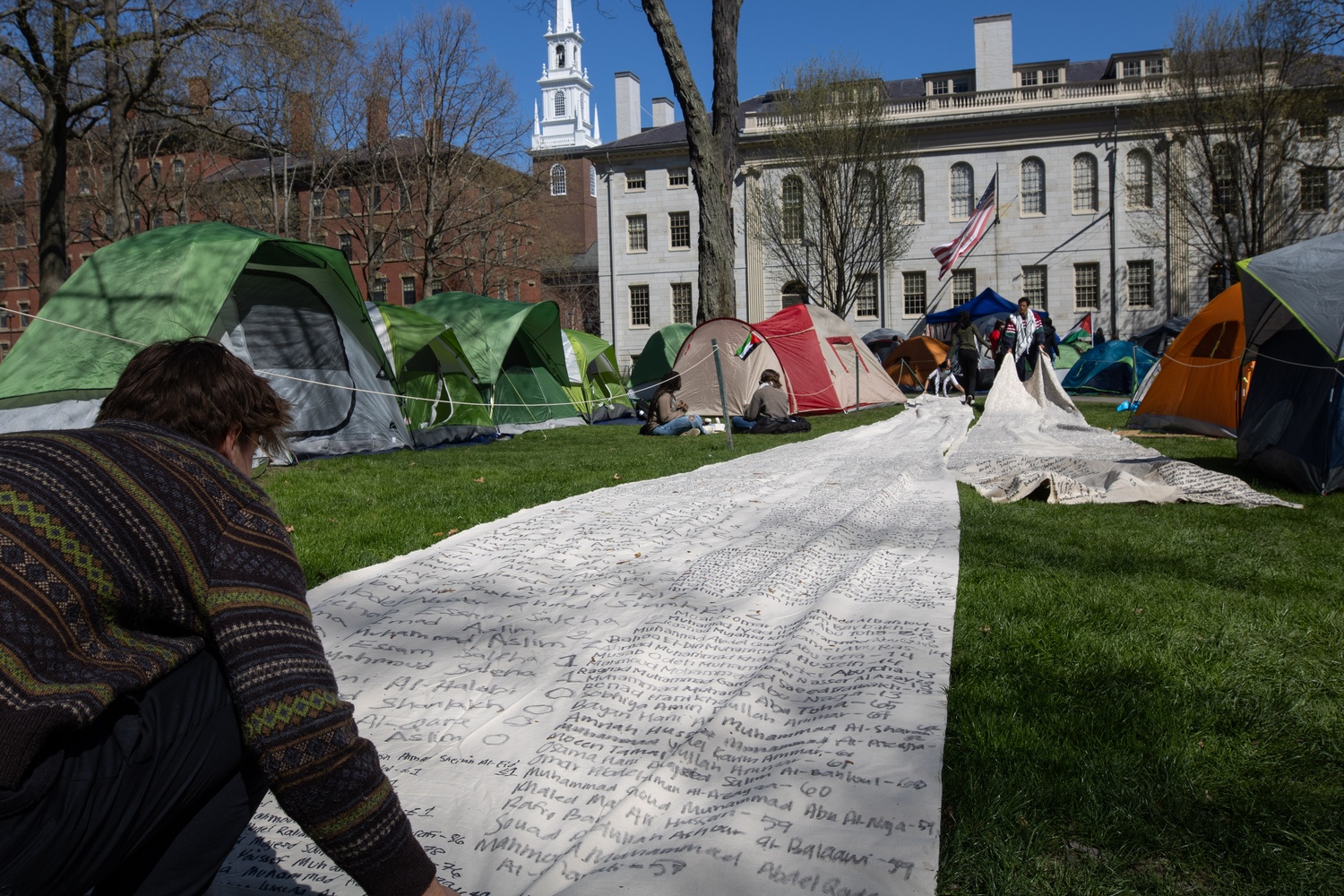 Students unfurl a more than 140-yard-long canvas listing the names of Palestinians killed in the violence in Gaza.