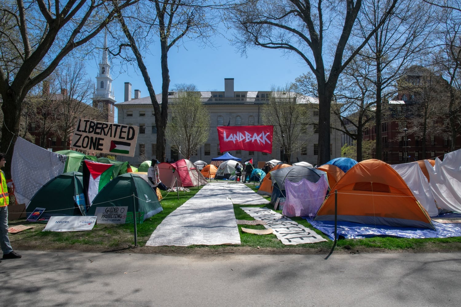Protesters set up tents and signs in front of University Hall, calling on Harvard to divest from Israel. Members of the encampment rejected a proposal from interim University President Alan M. Garber '76 to end their demonstration.