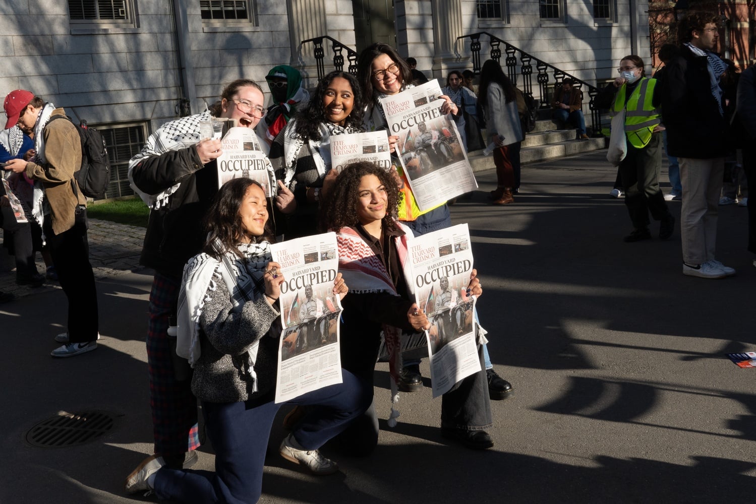 Protesters distributed and posed for photos with The Crimson's most recent print issue, which featured the encampment on the front page.