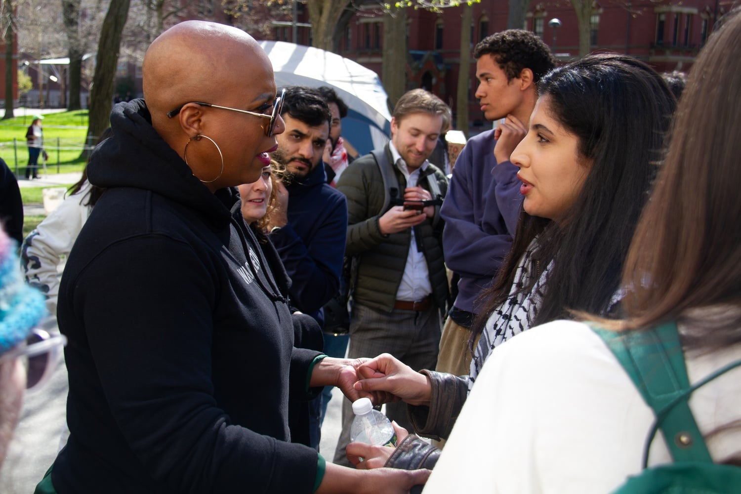 Rep. Ayanna S. Pressley (D-Mass.) speaks to a protester at the Harvard Yard encampment Firday.