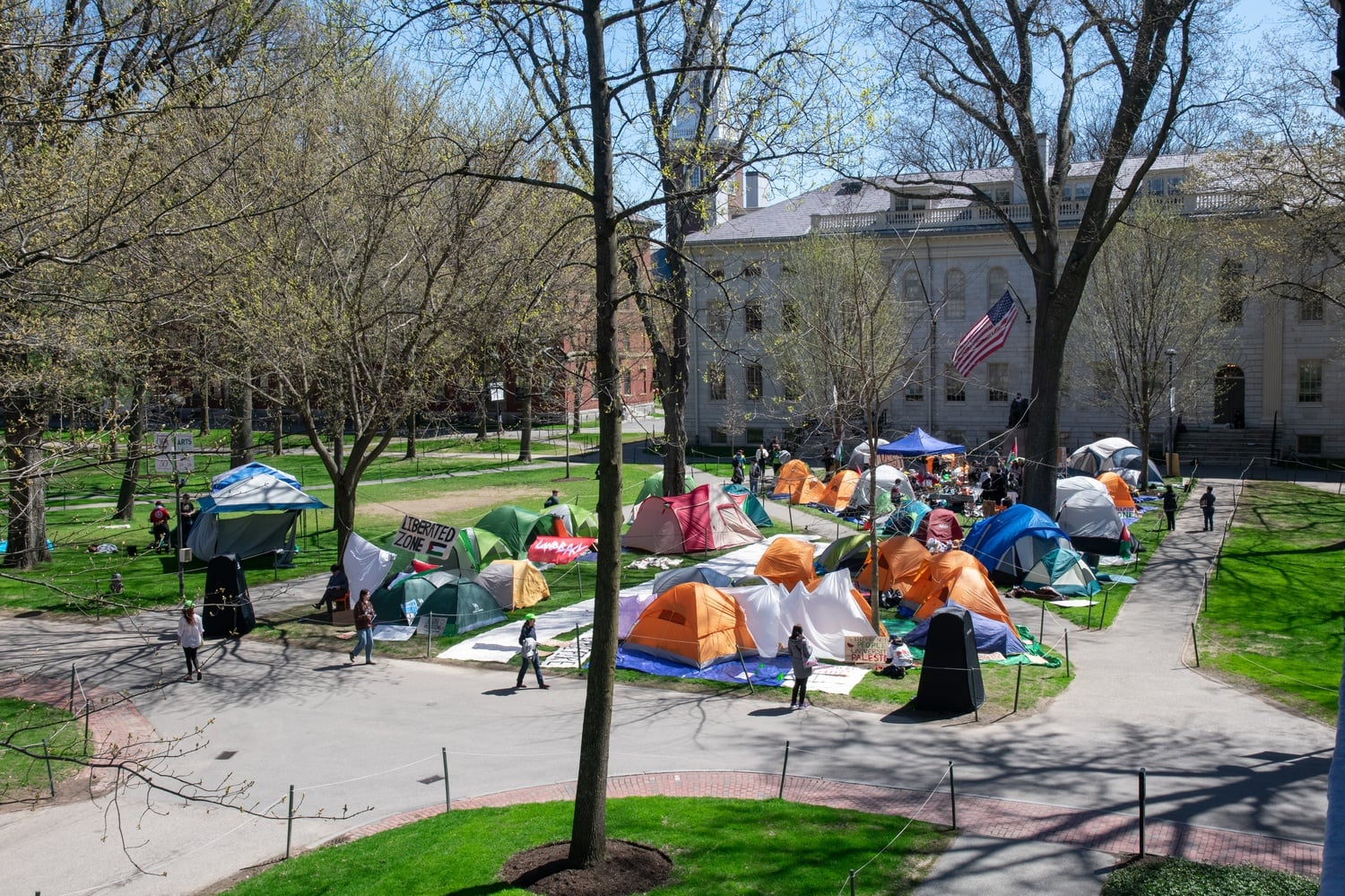 Pro-Palestine student protesters occupy Harvard Yard with tents and signs. Harvard College Dean of Students Thomas Dunne threatened disciplinary action against students who continue to participat in the College's second email since the encampment began.