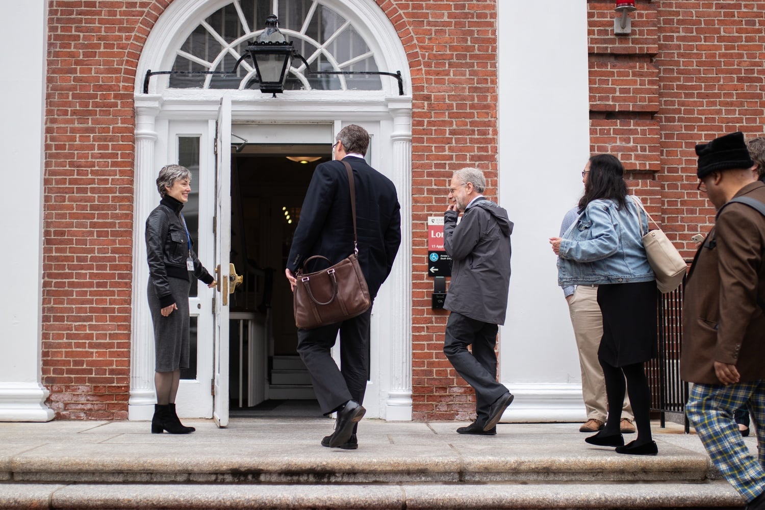 Faculty members enter the town hall, held at the Harvard Graduate School of Education. Though some were pleased at the opportunity to meet Corporation members, others emerged feeling like their questions were not adequately answered.