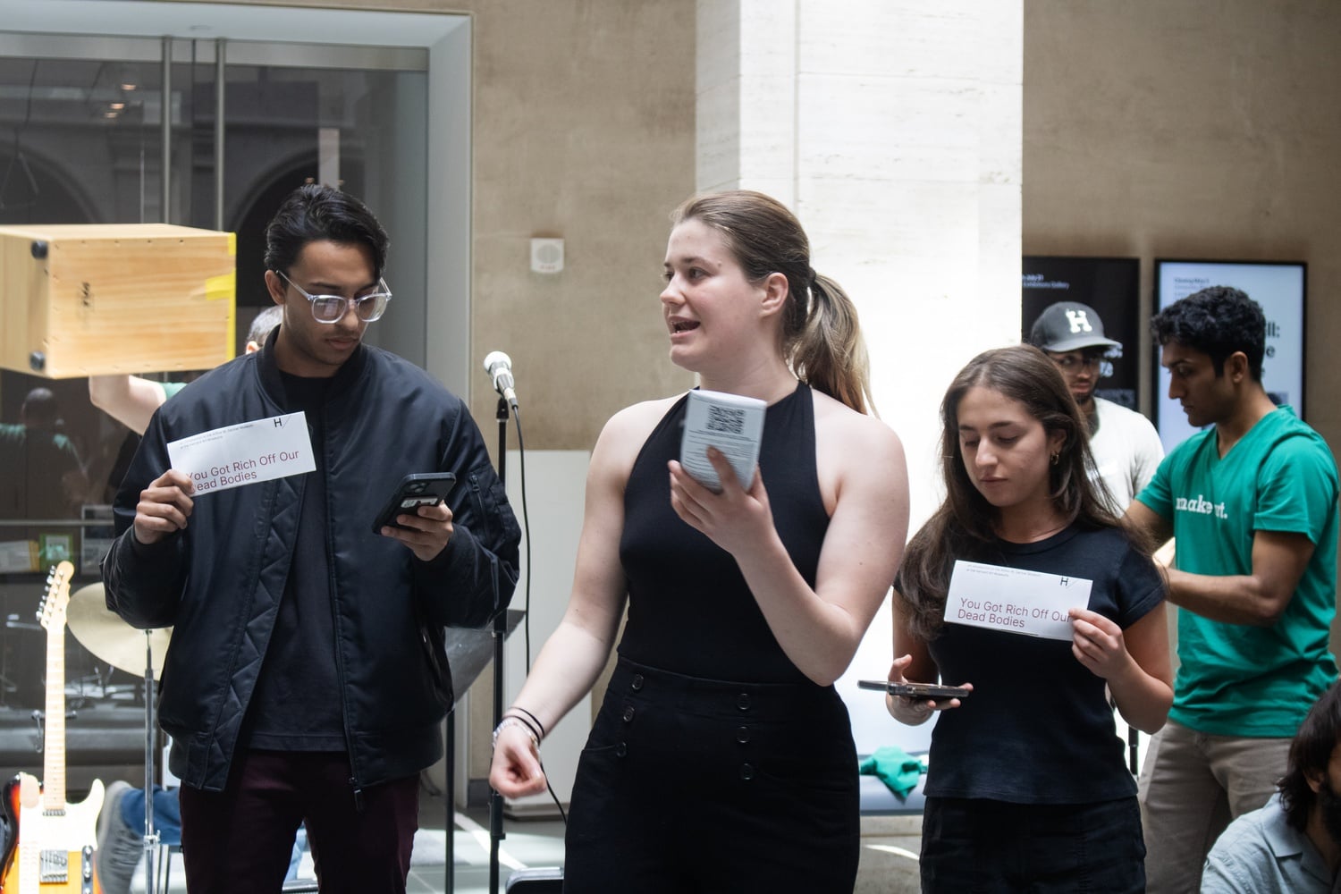 M.C. Hanafee LaPlante '25, middle, speaks at a protest at Sackler Museum Saturday afternoon.