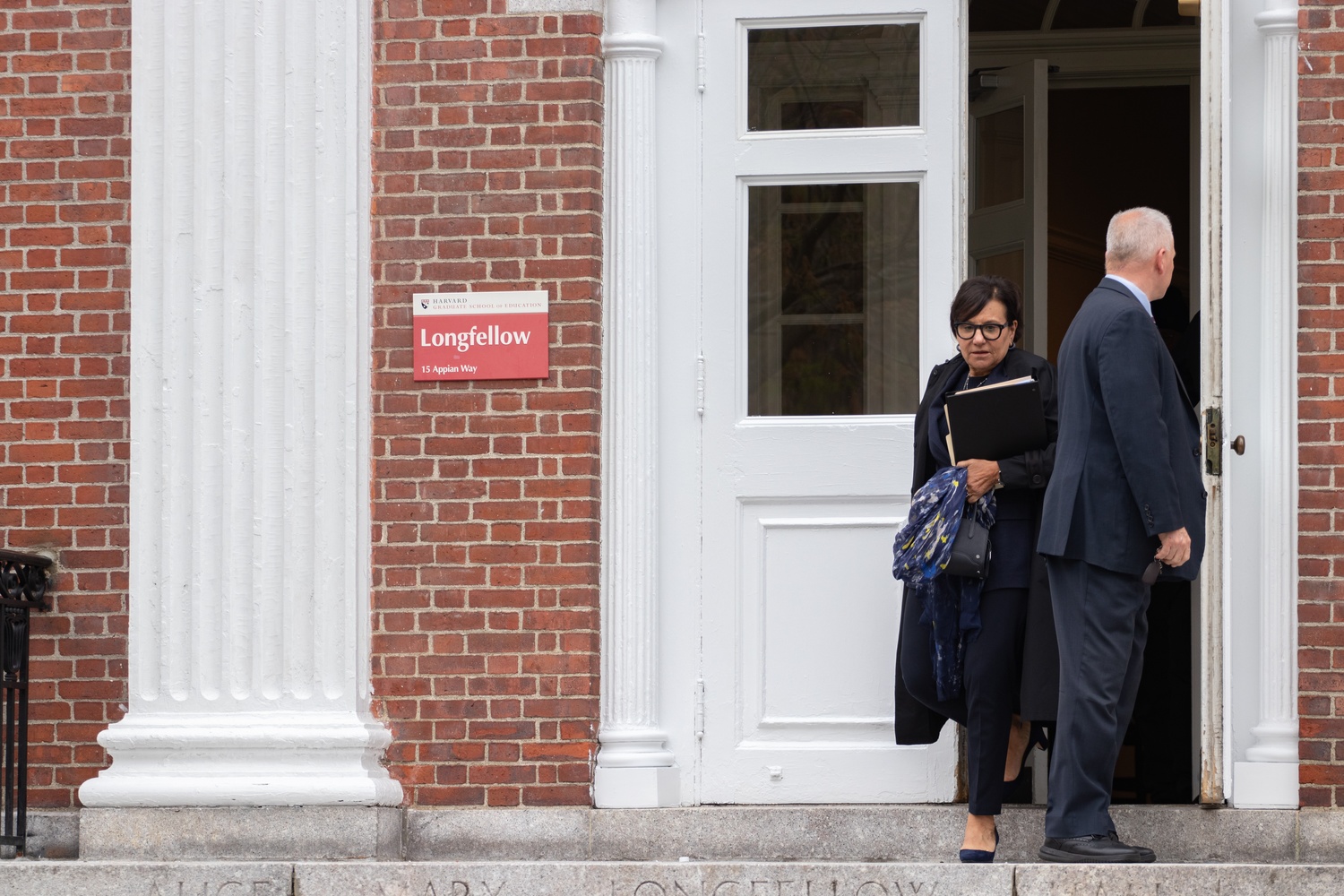 Harvard Corporation Senior Fellow Penny S. Pritzker '81 exits Longfellow Hall after a town hall in April with members of the Harvard Faculty of Arts and Sciences.