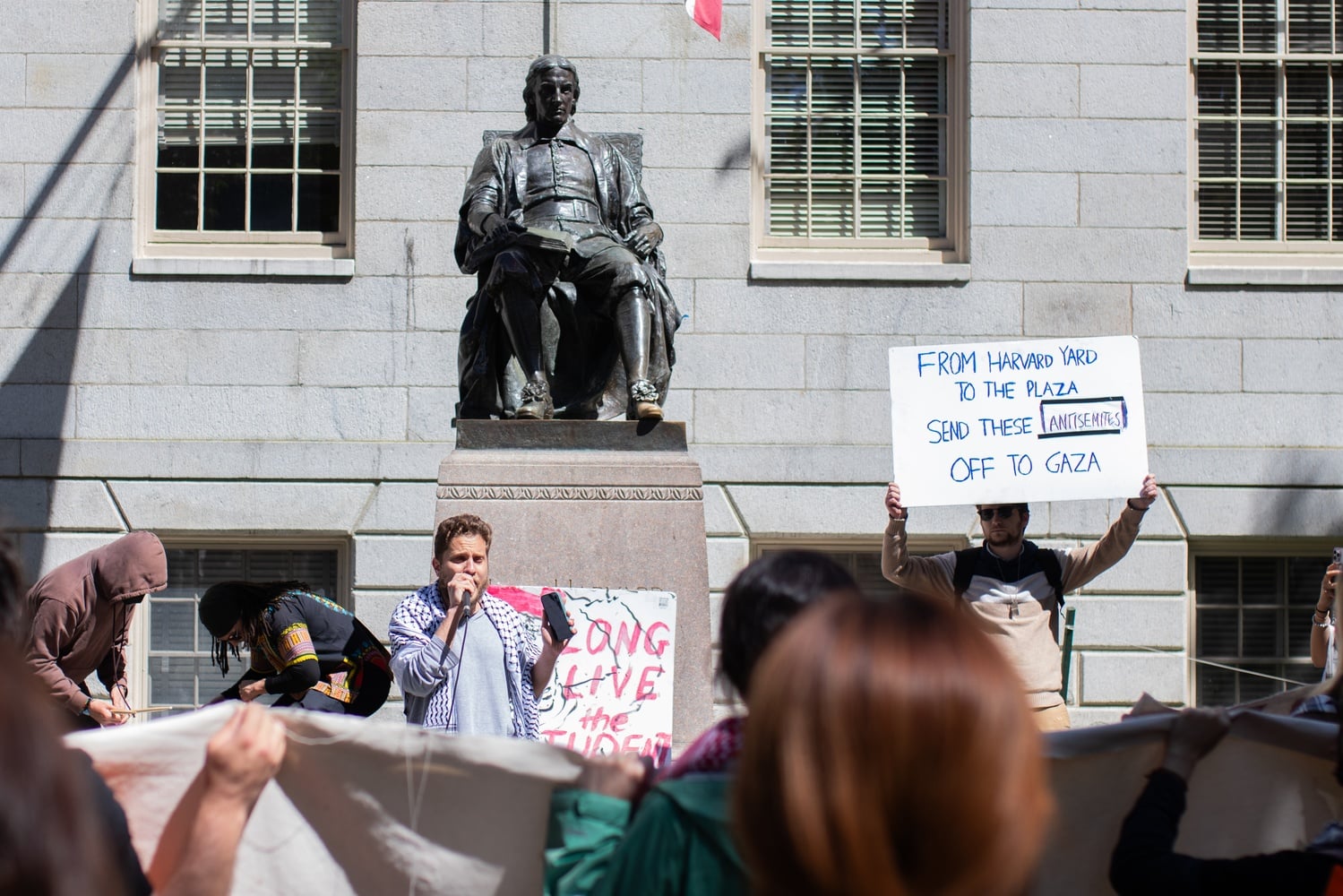 Shabbos “Alexander” Kestenbaum, a Harvard Divinity School student, attended the Friday rally  as a counterprotester. He held a sign that read “From Harvard Yard to the plaza send these antisemites off to Gaza.”