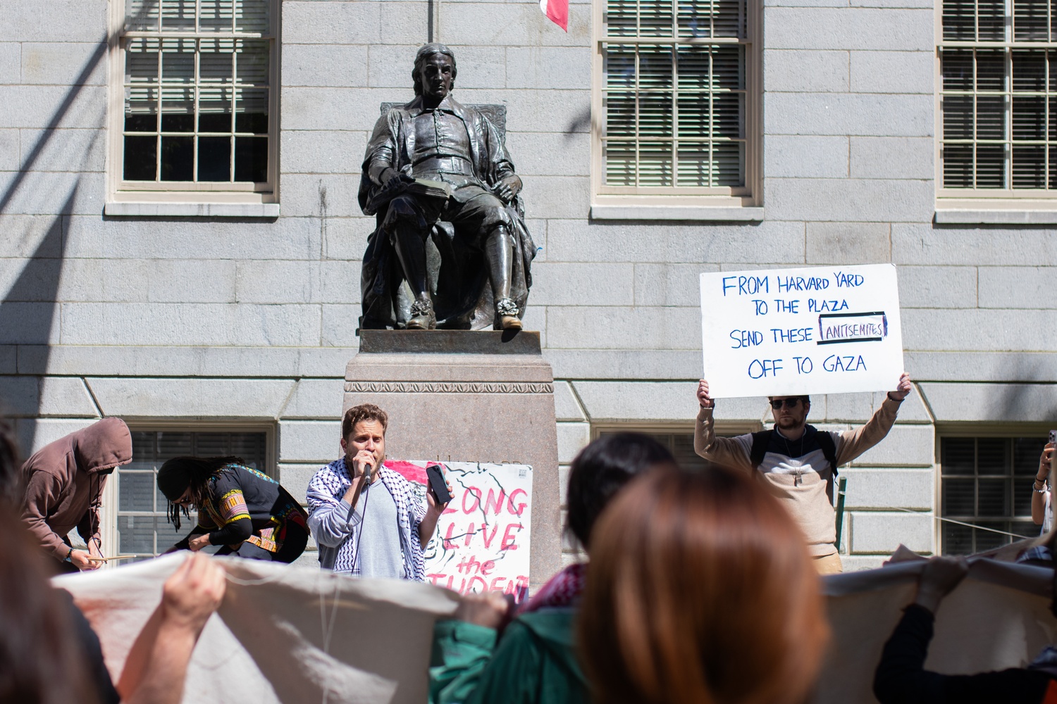 Shabbos “Alexander” Kestenbaum, a Harvard Divinity School student, attended the Friday rally  as a counterprotester. He held a sign that read “From Harvard Yard to the plaza send these antisemites off to Gaza.”