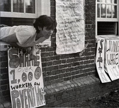 Cover image for Protester hangs out of window during 2001 PSLM Mass Hall Sit-In