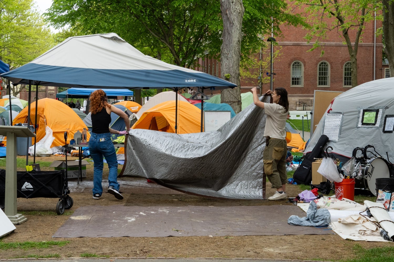 Protesters dismantle the Harvard Yard encampment Tuesday morning. Harvard Out of Occupied Palestine announced they had reached an agreement with the University to end the encampment in exchange for reversing involuntary leaves of absence and holding conversations with University leadership around divestment.